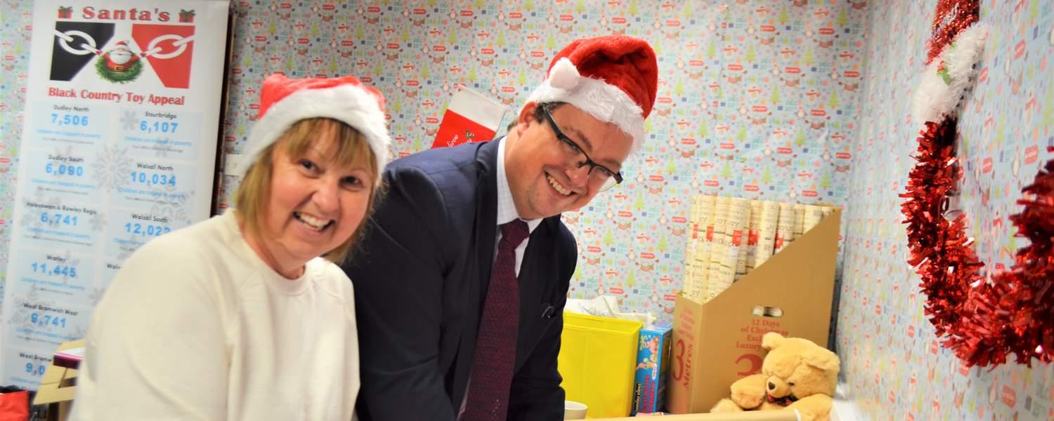 Mike Wood MP lends a hand with the wrapping at Santa's Black Country Toy Appeal grotto